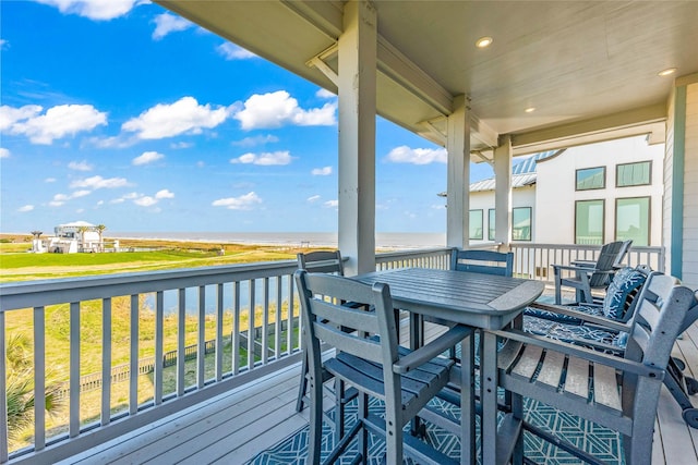 wooden terrace featuring a water view