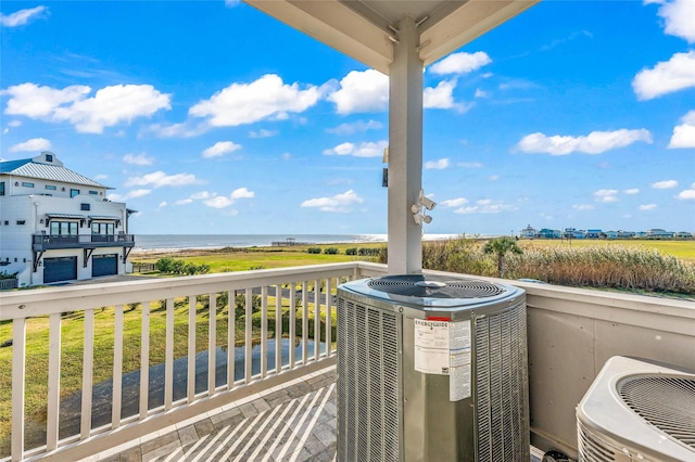 exterior space featuring central AC unit and a water view