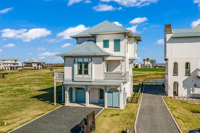 view of front facade featuring a garage, a front lawn, and a balcony