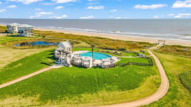 bird's eye view featuring a water view and a beach view