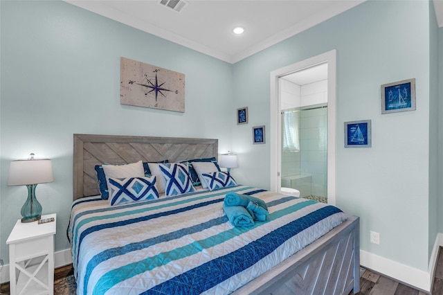 bedroom with crown molding, connected bathroom, and dark hardwood / wood-style flooring