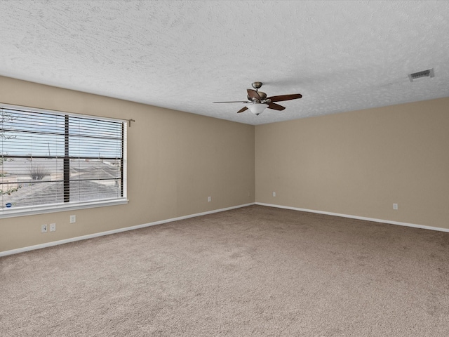 spare room with ceiling fan, carpet floors, and a textured ceiling