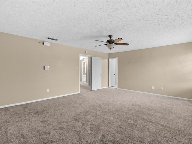 carpeted spare room featuring ceiling fan and a textured ceiling