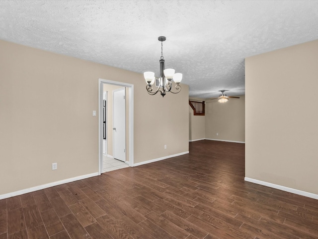 unfurnished room with ceiling fan with notable chandelier and a textured ceiling