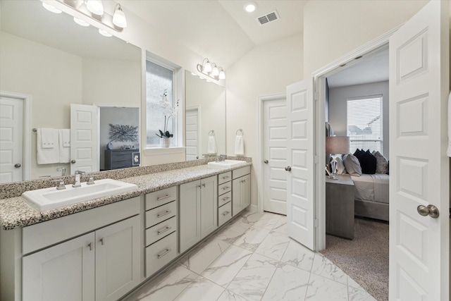 bathroom featuring vanity and vaulted ceiling