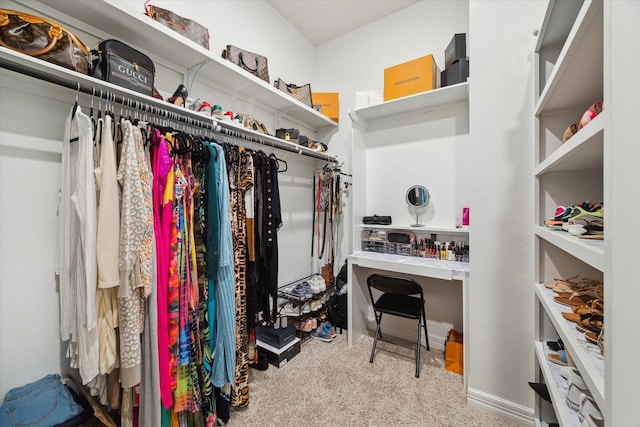 walk in closet featuring light carpet