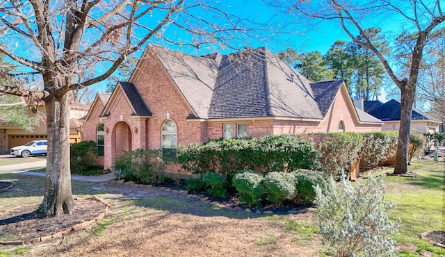 english style home with a front yard