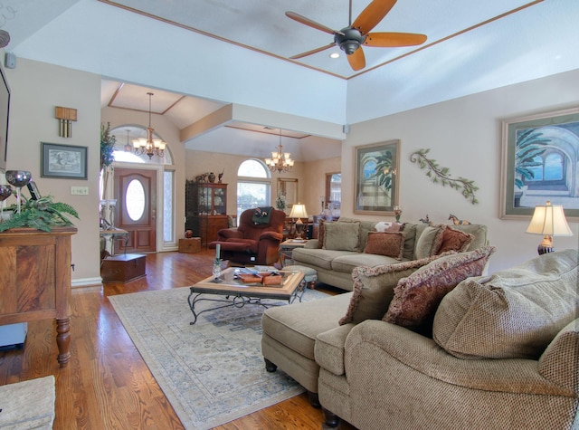 living room featuring ceiling fan with notable chandelier, vaulted ceiling, and hardwood / wood-style floors