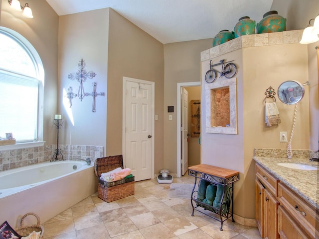 bathroom with vanity and a tub