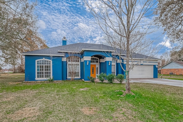 view of front facade with a garage and a front lawn