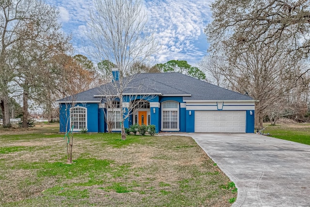 ranch-style house featuring a garage and a front yard