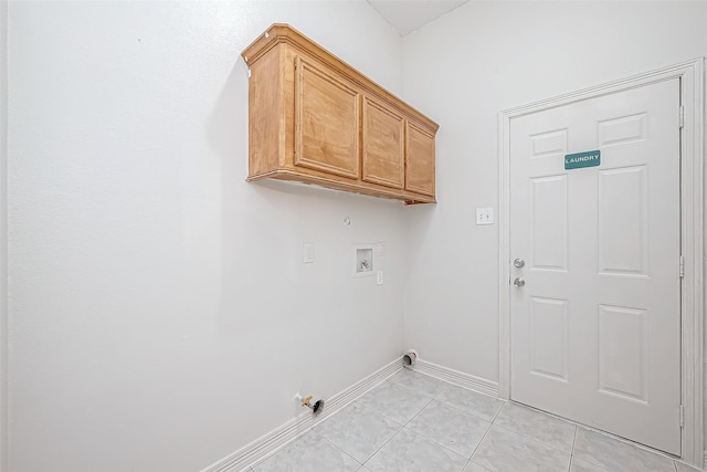 clothes washing area featuring hookup for a gas dryer, hookup for a washing machine, light tile patterned floors, and cabinets