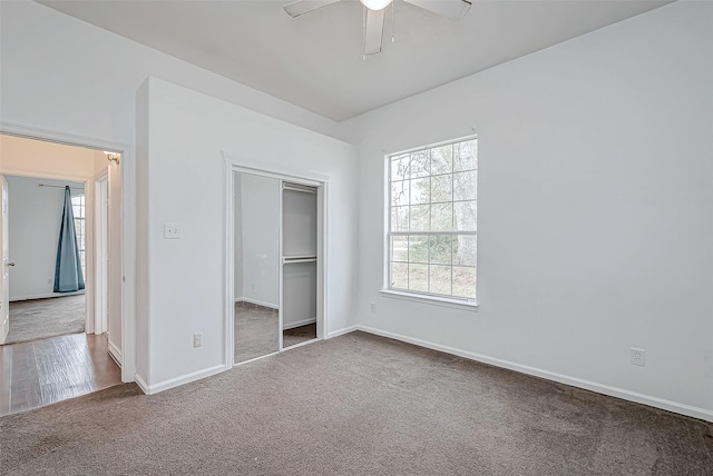 unfurnished bedroom featuring a closet, ceiling fan, and carpet