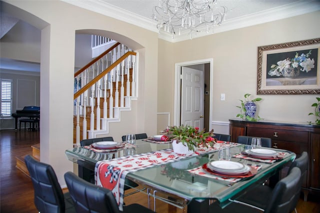 dining room featuring an inviting chandelier, ornamental molding, and dark hardwood / wood-style flooring