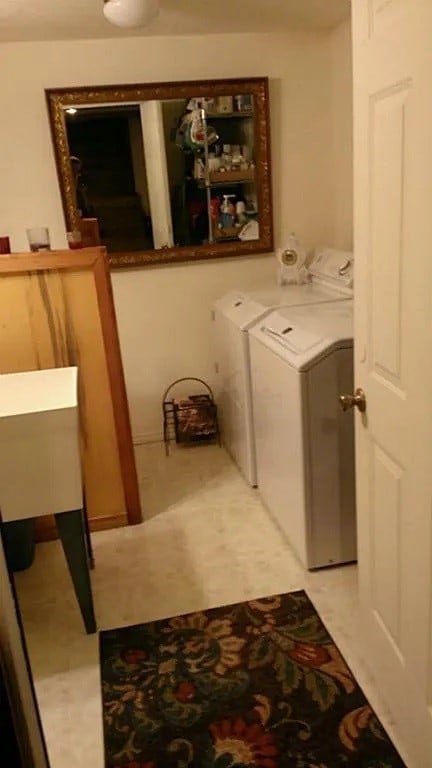 clothes washing area with separate washer and dryer