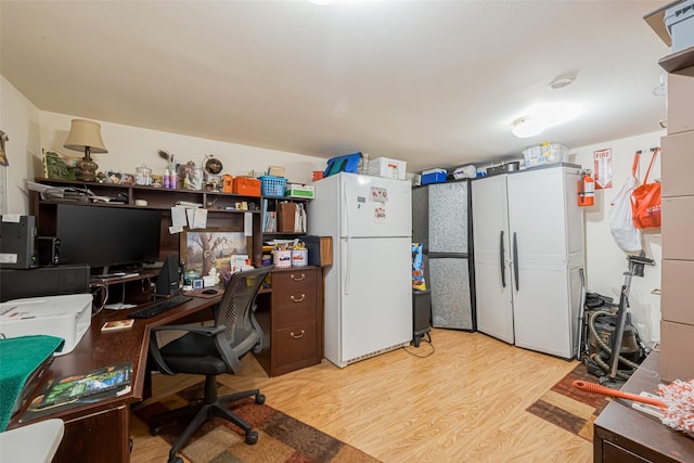 home office with light wood finished floors