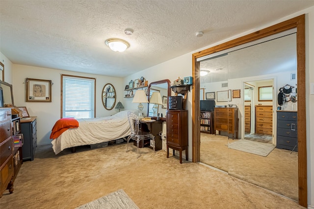 bedroom with a textured ceiling and carpet floors