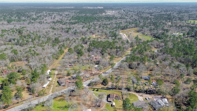 birds eye view of property with a wooded view