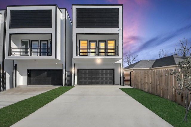 contemporary home with a garage and a balcony