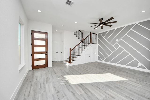 entryway with ceiling fan, a wealth of natural light, and light wood-type flooring