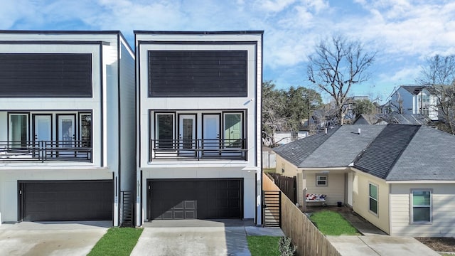 view of front of property with a balcony and a garage