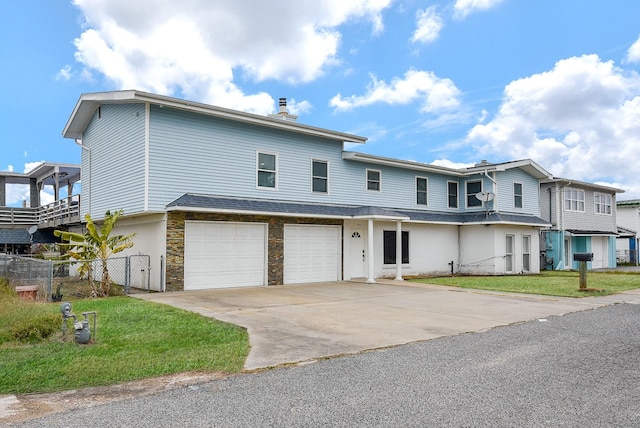 view of front of home with a garage and a front yard