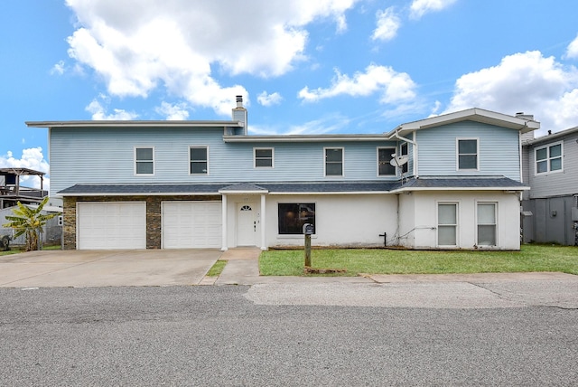 view of front of home featuring a garage and a front lawn