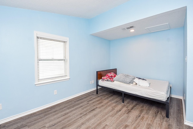 sitting room with wood-type flooring and a textured ceiling