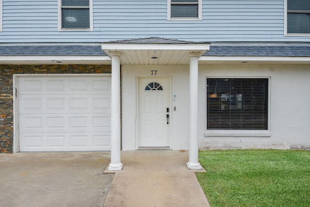 view of exterior entry with a garage