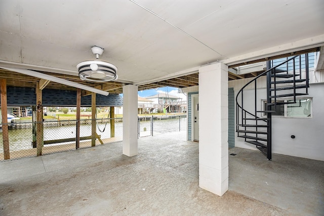 view of patio featuring a water view and ceiling fan