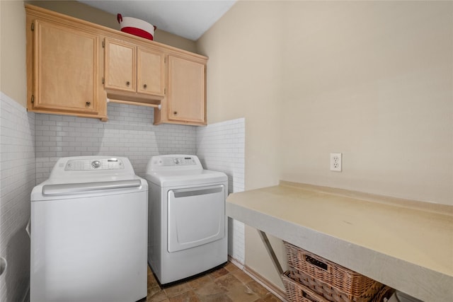 washroom featuring cabinets and washer and dryer