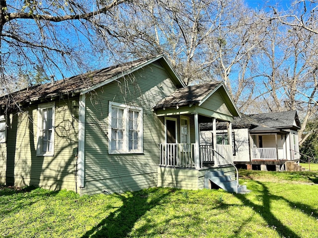 bungalow-style home with a front yard