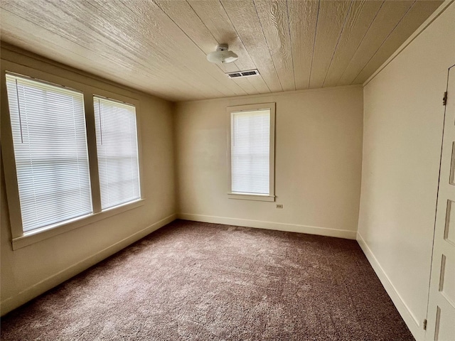 spare room with carpet and wooden ceiling