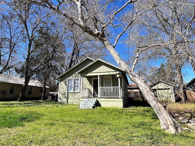 bungalow-style home with a front yard and a porch