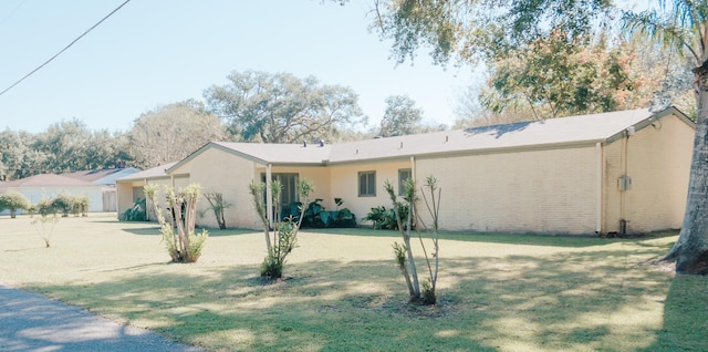 rear view of house featuring a lawn