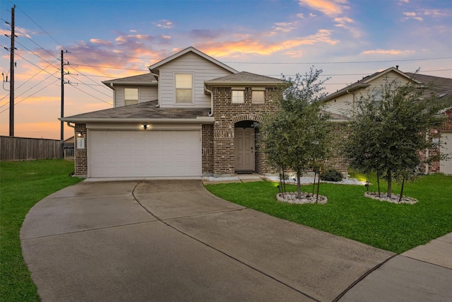 view of property with a garage and a yard