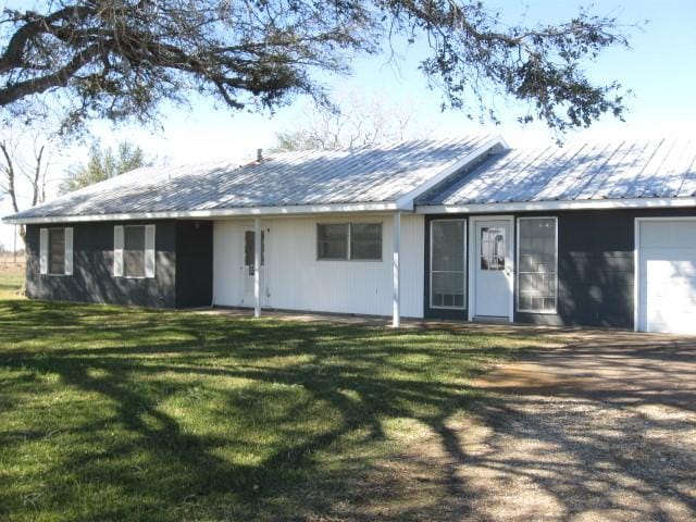 ranch-style house featuring a garage and a front yard