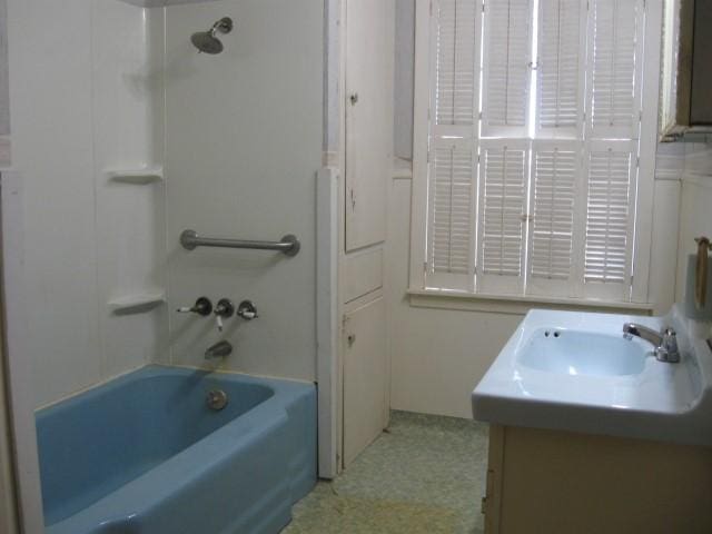 bathroom with vanity and  shower combination