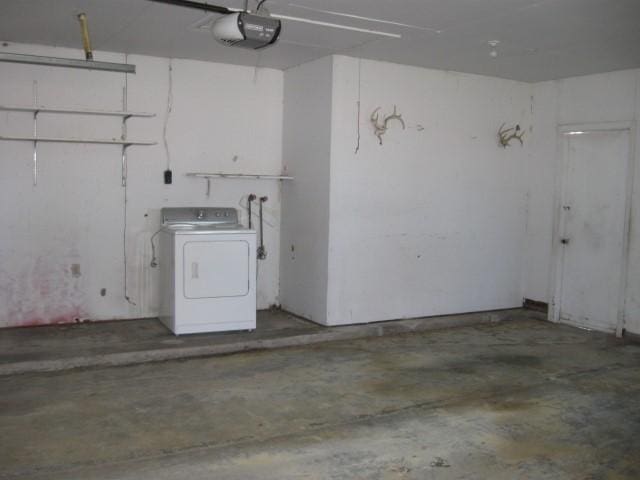 garage with a garage door opener and washer / dryer