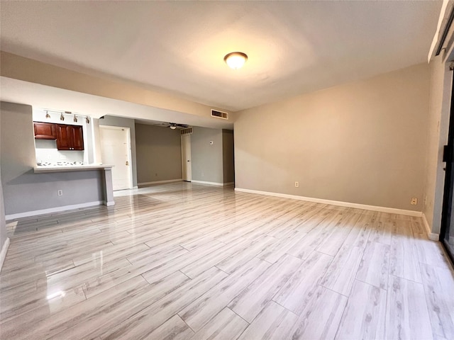 unfurnished living room featuring light hardwood / wood-style floors and ceiling fan