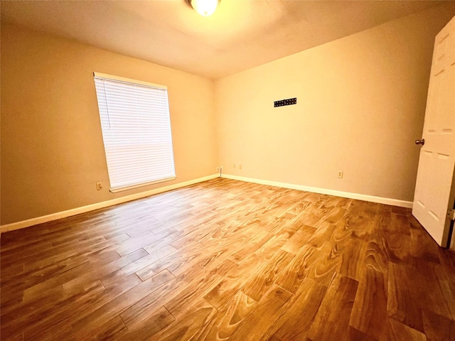 empty room with hardwood / wood-style floors