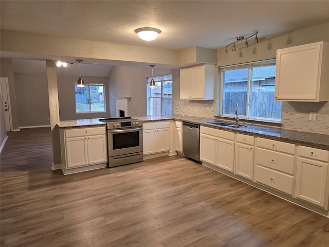 kitchen featuring pendant lighting, white cabinetry, appliances with stainless steel finishes, and sink