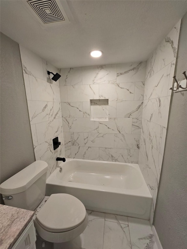 full bathroom featuring vanity, toilet, and tiled shower / bath combo