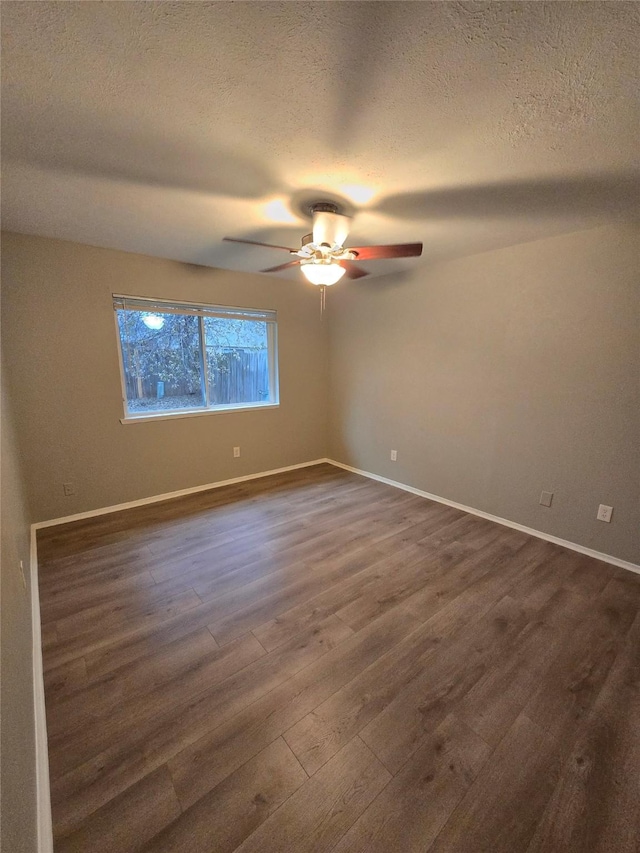 unfurnished room with dark hardwood / wood-style flooring, a textured ceiling, and ceiling fan