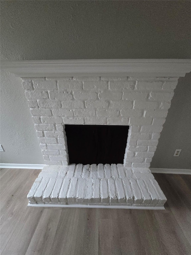 room details featuring a fireplace and hardwood / wood-style floors