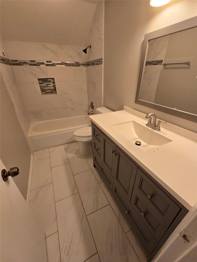 full bathroom featuring vanity, tiled shower / bath combo, and toilet