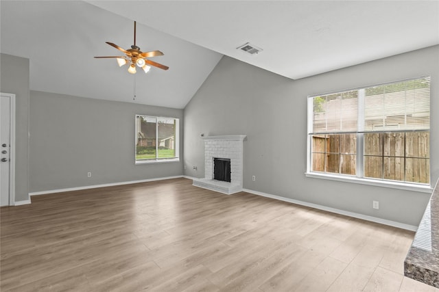 22706 Braken Carter Ln, Katy, TX 77449 - unfurnished living room featuring ceiling fan, a fireplace, wood finished floors, and high vaulted ceiling