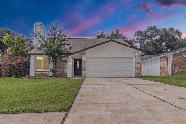 22706 Braken Carter Ln, Katy, TX 77449 - ranch-style home with an attached garage, concrete driveway, a front yard, a chimney, and brick siding