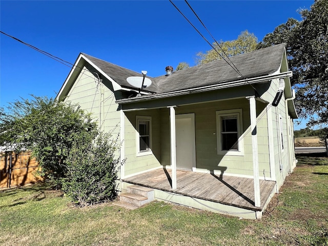 back of property with a lawn