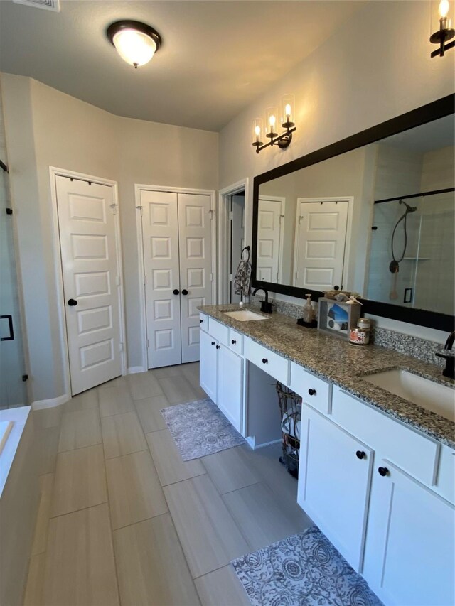 bathroom with an enclosed shower and vanity